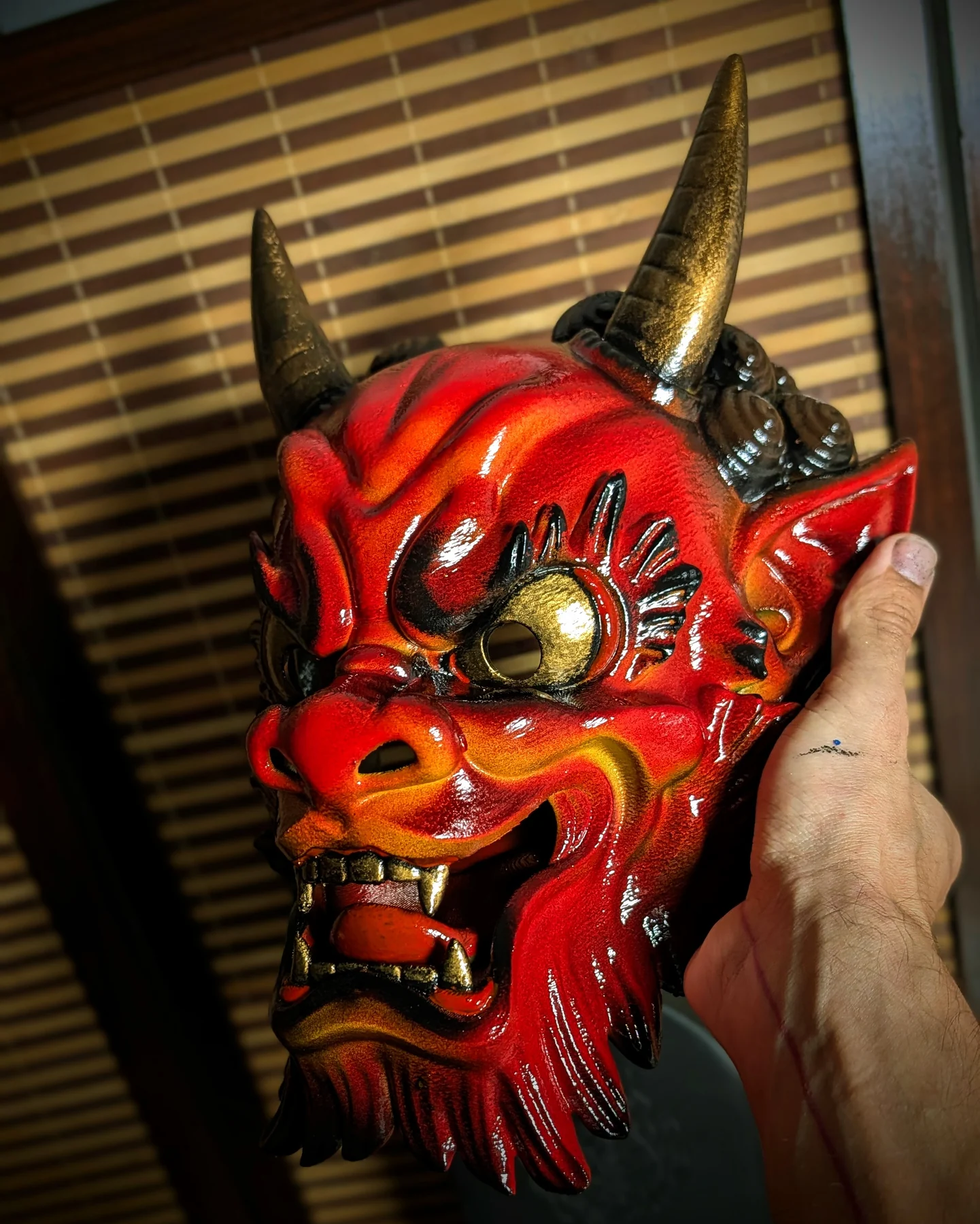 Handmade red Oni mask inspired by Japanese folklore and irezumi tattoo style.