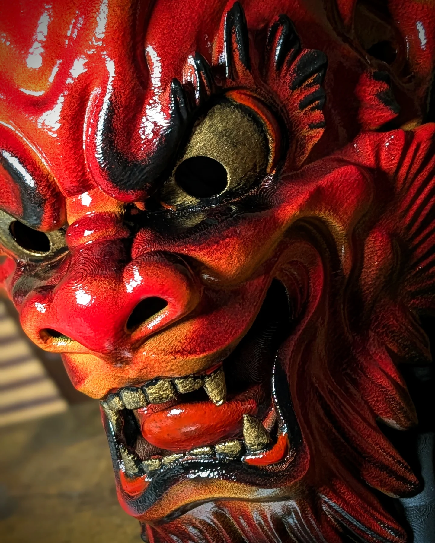 Close-up of the hand-painted details on a red Irezumi Oni Mask.